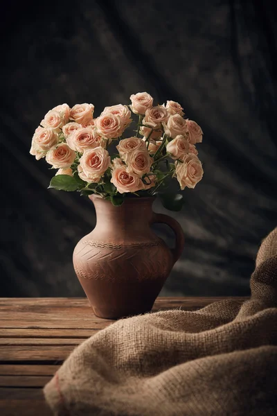 Gorgeous still life with roses on wooden table