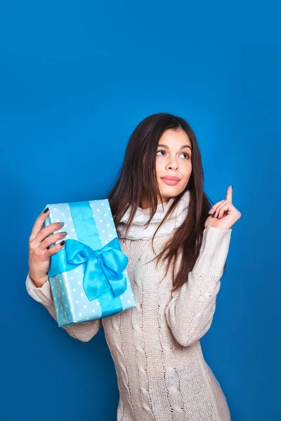 Smiling woman hold blue gift box. Christmas, x-mas, people, happiness concept - happy woman in winter clothes