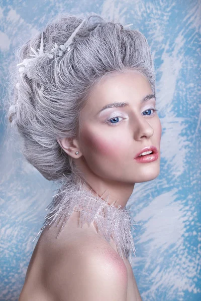 Snow Queen.Fantasy girl portrait. Winter fairy portrait.Young woman  with creative silver artistic make-up. Winter Portrait.