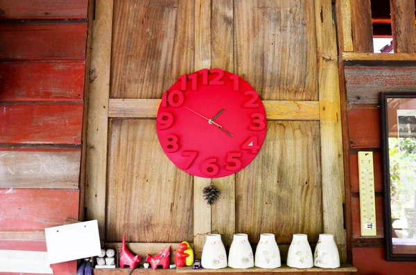 Interior decorate with red clock on wooden wall