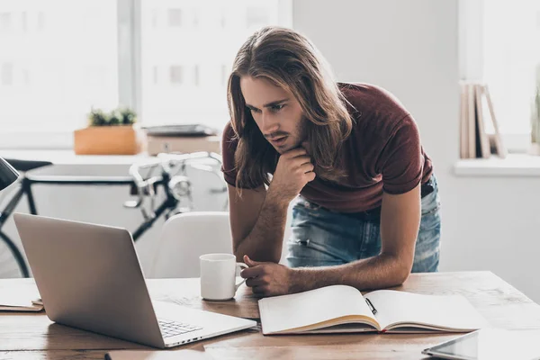 Young businessman with long hair