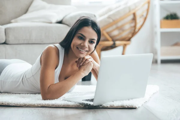 Attractive woman surfing web at home