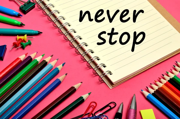The words Never stop on notebook