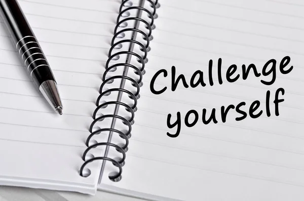 The words Challenge yourself on notebook