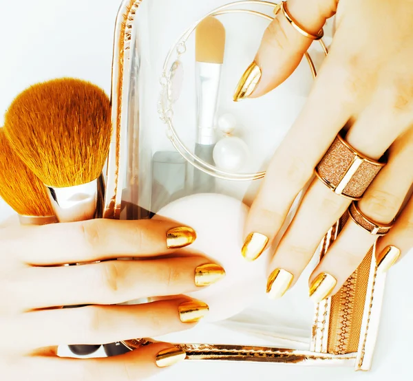 Woman hands with golden manicure
