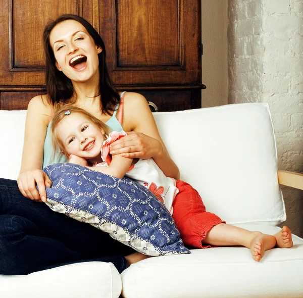 Mother with daughter together in bed smiling, happy family close up, lifestyle people concept, cool real modern family