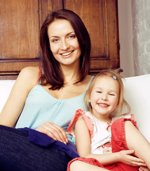 Mother with daughter together in bed smiling, happy family close up, lifestyle people concept, cool real modern family