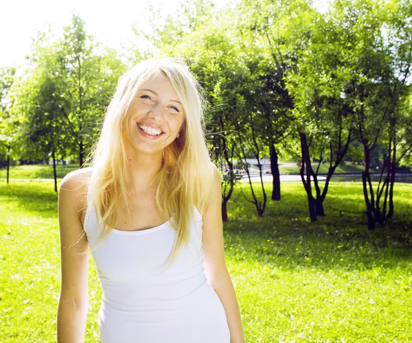 Happy cute blond girl smiling walking in green park, lifestyle people concept