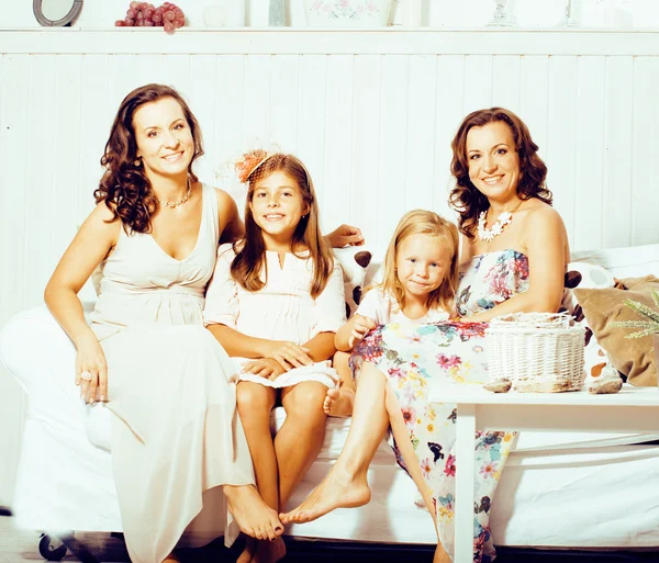 Mature sisters twins at home with little cute daughter, happy real family smiling together, lifestyle people concept
