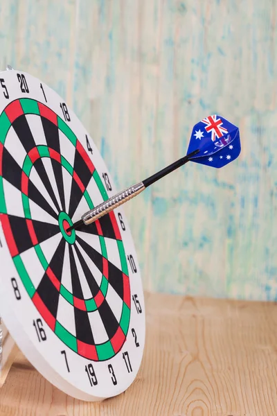 Darts arrow with Australia flags on red dart board