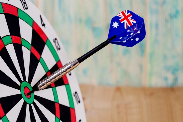 Darts arrow with Australia flags on red dart board