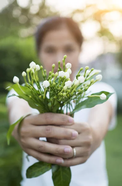 http://st3.depositphotos.com/3059589/12943/i/450/depositphotos_129432528-stock-photo-asian-woman-hokding-flowers-in.jpg