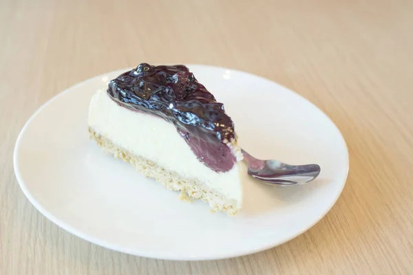 Blackberries cheesecake on a plate.