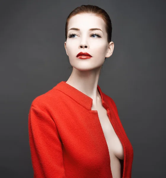 Fashion art studio photo of elegant lady in red coat