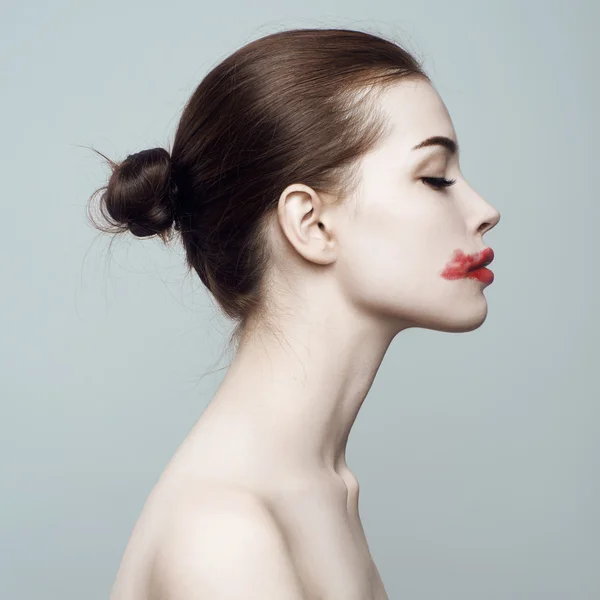 Fashion beautiful woman with smeared lipstick in profile