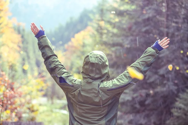 Happy traveler in autumn forest mountain  landscape