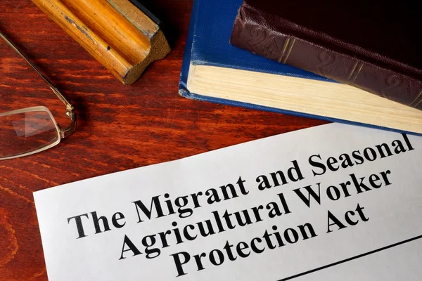 The Migrant and Seasonal Agricultural Worker Protection Act and a book. awpa/mspa