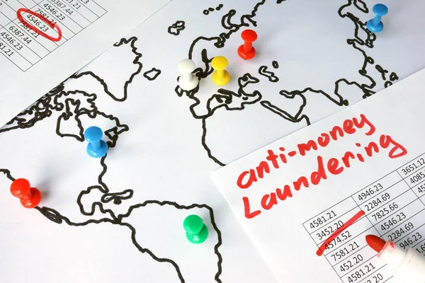 Anti-money laundering (AML) concept. Data and thumb tacks in a map.