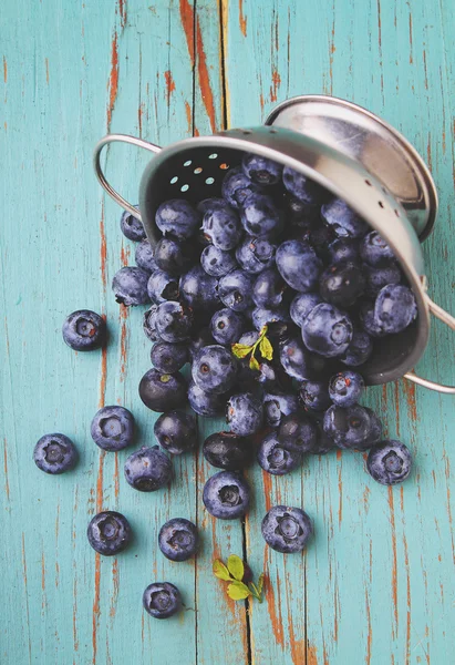 Scattered blueberries on blue table