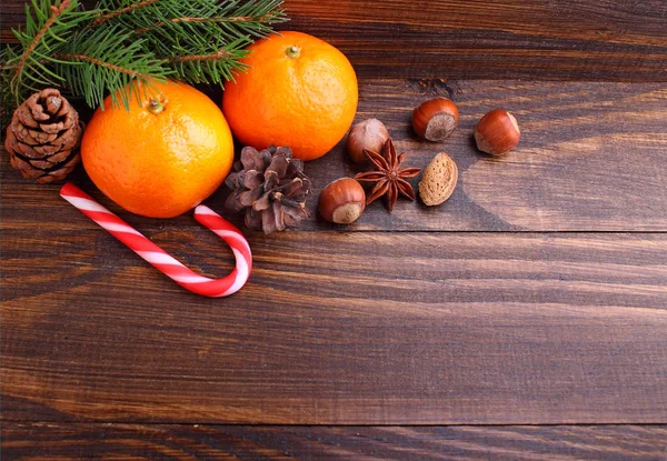 Christmas spirit: nuts, tangerines, Christmas tree