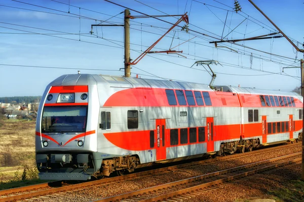 Lithuanian, Vilnius 2014-07-11 beautiful modern passenger train tensporting people to next station. beautiful sunny day, beautiful red and grey train, train background.