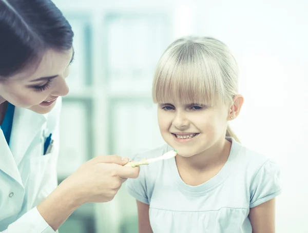 Dentist and little girl in the dentist office.