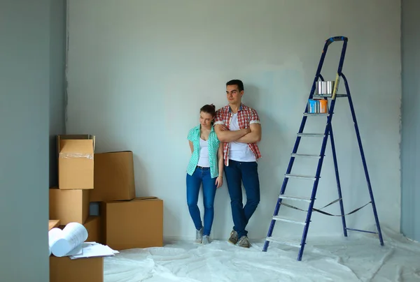 Portrait of young couple moving in new home