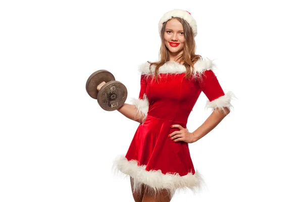 Christmas, x-mas, winter, happiness concept - Bodybuilding. Strong fit woman exercising with dumbbells in santa helper hat , isolated on White Background. Muscular blonde girl lifting weights studio