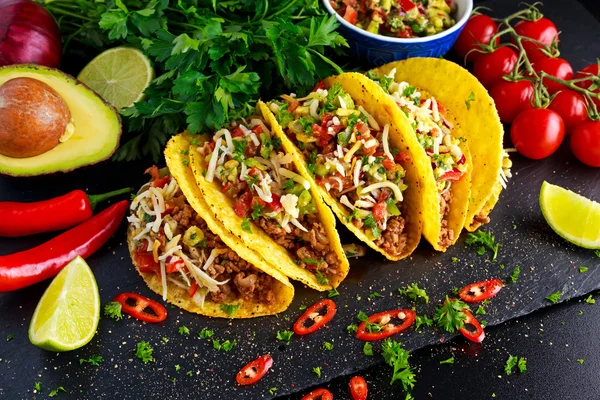 Mexican food - delicious taco shells with ground beef and home made salsa