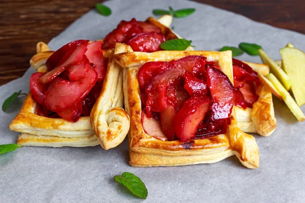 Puff pastry pies with plums, apples, mint and honey