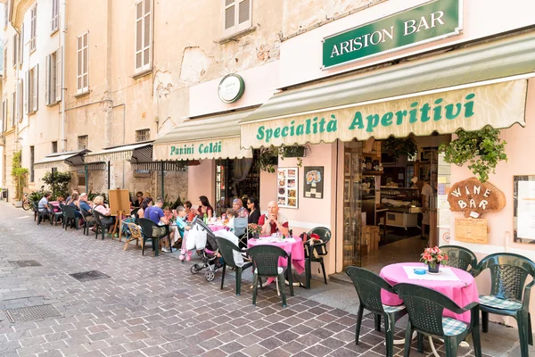 People enjoying a street wine bar in historic center of Como.