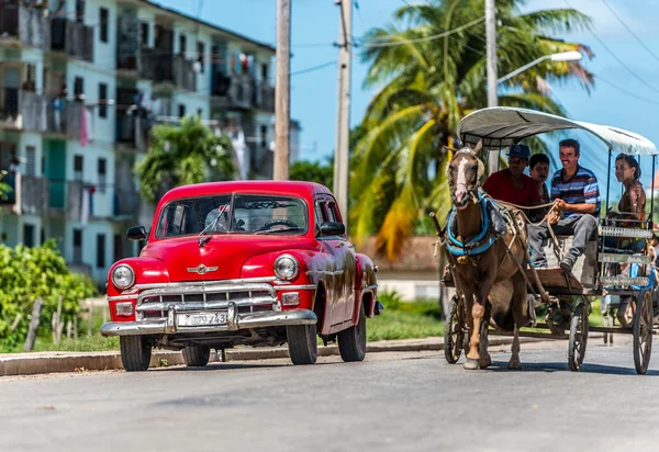 Varadero, Cuba - September 03, 2016: HDRI - Red american classic car parked on the street with carriage in Cuba - Serie Cuba 2016 Reportage