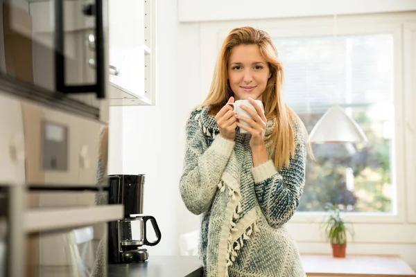 Woman holding cup of hot coffee in hands