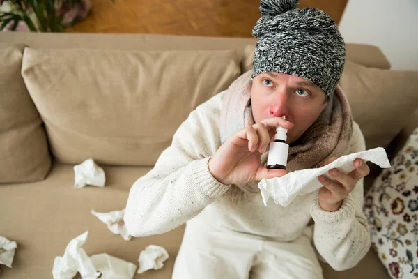 Sick man having red runny nose