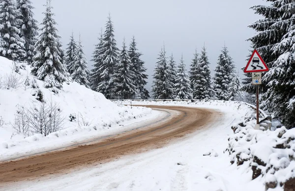 Winter road goes away to the mountains