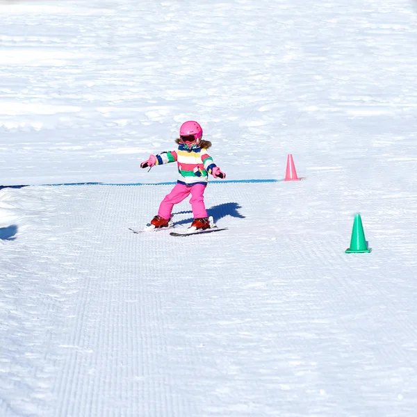 Little skier girl enjoying winter ski vacation