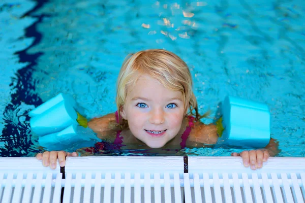 Healthy toddler swimming in the pool