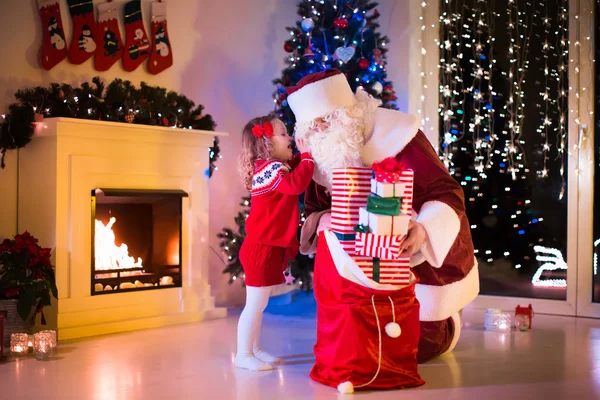 Kids and Santa opening Christmas presents