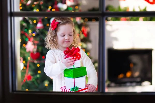 Little girl opening presents on Christmas morning