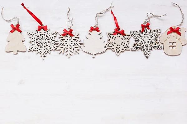 Christmas soft beige wooden snowflakes on a wood white  background.