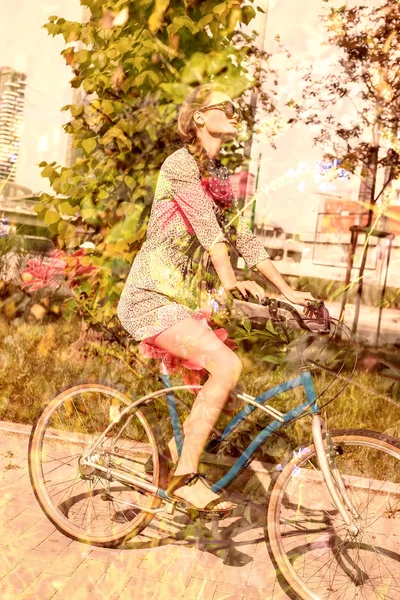 Double exposure of woman riding bike and nature background