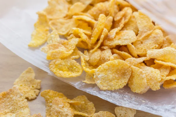 Corn-flakes overflow from plastic bag