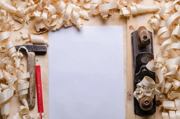 wood shavings on a wooden background with tools