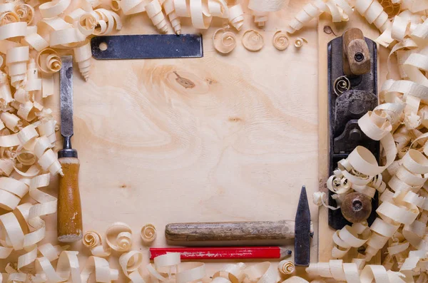 wood shavings on a wooden background with tools