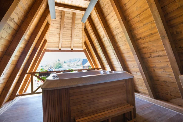 Hot tub with wooden frame on mountain hotel terace