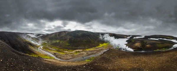 Dark Iceland landscape with green moss and steaming geothermal hot water, Iceland