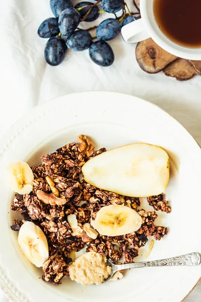 Homemade chocolate granola with banana and peanut butter