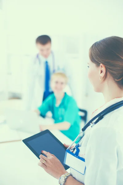 Attractive female doctor in front of medical group