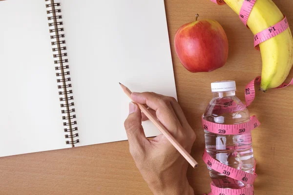 Healthy eating concept, tape measure, fruit and water bottle on