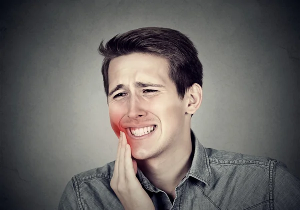 Man with toothache crown problem about to cry from pain